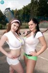 Busty chicks press their hooters together after getting naked on tennis court