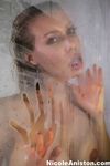 Busty MILF Nicole Aniston licks the steamy walls of the shower stall
