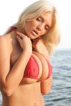 Hot MILF Ines Cudna relases her huge boobs from bikini along a seawall