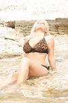 Blonde bombshell Ines Cudna takes off her bikini while sitting in a stream