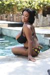 Busty and slender ebony Maserati shows her big wet boobs by the pool
