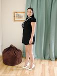 Fully clothed model shows off her white pumps in a short dress