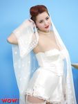 Natural redhead Lucy V slips off her wedding dress to bare big natural tits