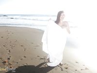 Buxom pornstar Tessa Fowler modeling topless outdoors on beach