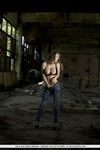 Latvian solo model Viola Bailey peels off jeans in an abandoned building
