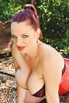 Redhead slut exposes her massive breasts outdoors