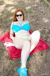 Redhead BBW Alexsis Faye unleashes her large boobs from bikini by dirty water