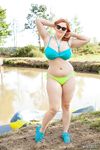 Redhead BBW Alexsis Faye unleashes her large boobs from bikini by dirty water