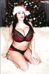 Sexy topless Christmas photo shoot with busty brunette Leanne Crow