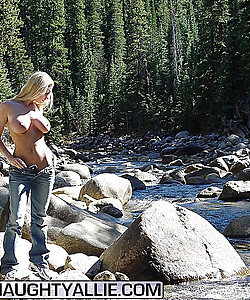 Hot blonde amateur Naughty Allie uncovers her great tits on rocks in a stream