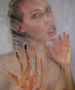 Busty MILF Nicole Aniston licks the steamy walls of the shower stall