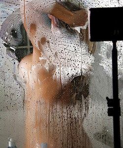 Busty MILF Nicole Aniston licks the steamy walls of the shower stall