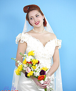 Natural redhead Lucy V slips off her wedding dress to bare big natural tits