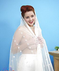 Natural redhead Lucy V slips off her wedding dress to bare big natural tits