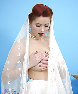 Natural redhead Lucy V slips off her wedding dress to bare big natural tits