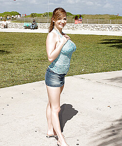 Busty redhead Christy Marks posing outdoor in jean miniskirt and white shirt