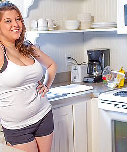 Two sexy best friends in short shorts strip down to their bras in the kitchen