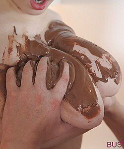 Busty Buffy covers huge tits with chocolate while giving a blowjob