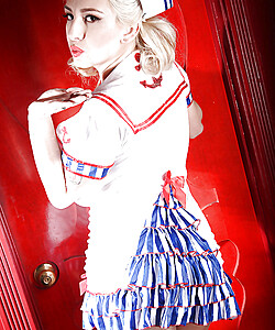 Blonde pinup model September Carrino striking sexy poses in sailor uniform