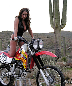 Chesty MILF Eva Notty pretends to be a biker posing topless with a hot machine