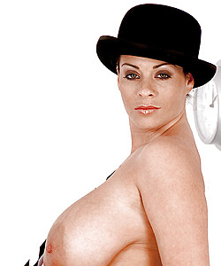 MILF solo girl Linsey Dawn McKenzie posing in hat while exposing huge juggs