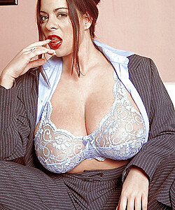 Fat MILF with big tits Linsey Dawn McKenzie posing in a suit.